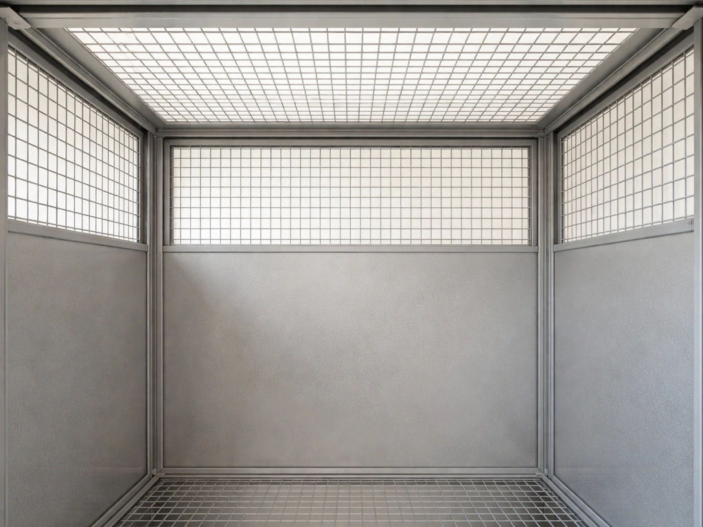 Empty bird cage interior showing back wall and ceiling open stainless mesh for ventilation.